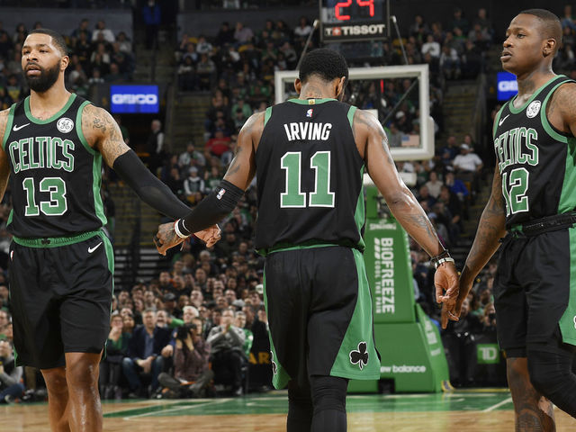 BOSTON, MA - MARCH 24: Marcus Morris #13 Kyrie Irving #11 and Terry Rozier #12 of the Boston Celtics high five against the San Antonio Spurs on March 24, 2019 at the TD Garden in Boston, Massachusetts. Mandatory Copyright Notice: Copyright 2019 NBAE