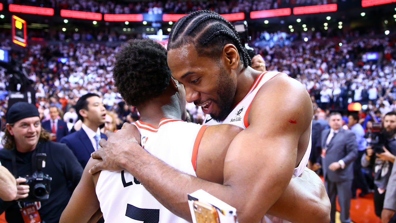 TORONTO, ON - MAY 12: Kawhi Leonard #2 (R) of the Toronto Raptors speaks with Kyle Lowry #7 after sinking a buzzer beater to win Game Seven of the second round of the 2019 NBA Playoffs against the Philadelphia 76ers at Scotiabank Arena on May 12, 2019 in Toronto, Canada.