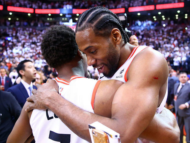 TORONTO, ON - MAY 12: Kawhi Leonard #2 (R) of the Toronto Raptors speaks with Kyle Lowry #7 after sinking a buzzer beater to win Game Seven of the second round of the 2019 NBA Playoffs against the Philadelphia 76ers at Scotiabank Arena on May 12, 2019 in Toronto, Canada.