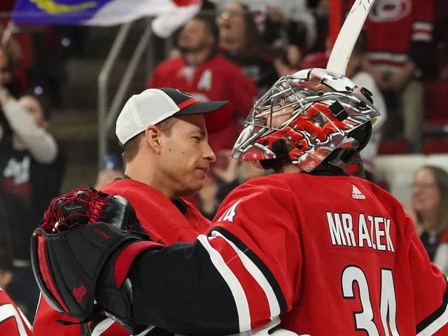 RALEIGH, NC - APRIL 04: Carolina Hurricanes Goalie Curtis McElhinney (35) and Carolina Hurricanes Goalie Petr Mrazek (34) celebrate after the Carolina Hurricanes clinch their first playoff birth since 2009 during a game between the New Jersey Devils and the Carolina Hurricanes at the PNC Arena in Raleigh, NC on April 4, 2019.