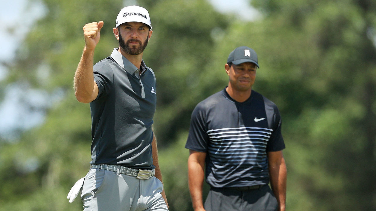 SOUTHAMPTON, NY - JUNE 15: Dustin Johnson of the United States celebrates making a birdie on the seventh hole as Tiger Woods of the United States looks on during the second round of the 2018 U.S. Open at Shinnecock Hills Golf Club on June 15, 2018 in Southampton, New York.