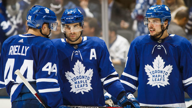 TORONTO, ON - JANUARY 7: John Tavares #91, Morgan Rielly #44, and Auston Matthews #34 of the Toronto Maple Leafs speak in a break against the Nashville Predators during the third period at the Scotiabank Arena on January 7, 2019 in Toronto, Ontario, Canada.