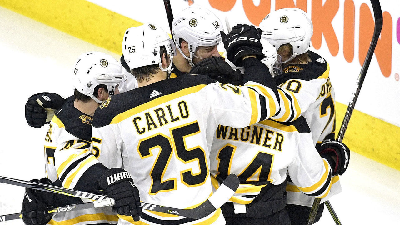 RALEIGH, NORTH CAROLINA - MAY 14: Chris Wagner #14 of the Boston Bruins celebrates with his teammates after scoring a goal on Curtis McElhinney #35 of the Carolina Hurricanes during the second period in Game Three of the Eastern Conference Finals during the 2019 NHL Stanley Cup Playoffs at PNC Arena on May 14, 2019 in Raleigh, North Carolina.
