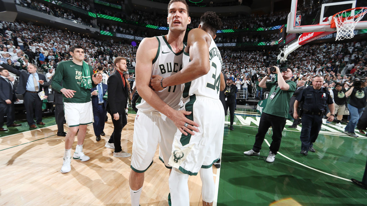 MILWAUKEE, WI - MAY 15: Brook Lopez #11 and Giannis Antetokounmpo #34 of the Milwaukee Bucks hug after defeating the Toronto Raptors in Game One of the Eastern Conference Finals of the 2019 NBA Playoffs on May 15, 2019 at the Fiserv Forum Center in Milwaukee, Wisconsin. Mandatory Copyright Notice: Copyright 2019 NBAE .