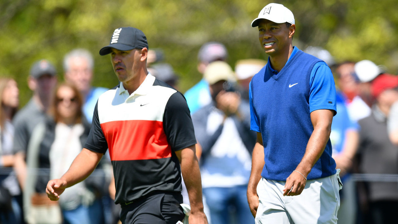 FARMINGDALE, NEW YORK - MAY 16: Brooks Koepka of the United States and Tiger Woods of the United States walk along the third hole during the first round of the 2019 PGA Championship at the Bethpage Black course on May 16, 2019 in Farmingdale, New York.