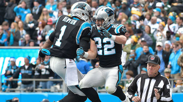 CHARLOTTE, NC - DECEMBER 17: Christian McCaffrey #22 celebrates with teammate Cam Newton #1 of the Carolina Panthers after a touchdown against the Green Bay Packers in the first quarter during their game at Bank of America Stadium on December 17, 2017 in Charlotte, North Carolina.