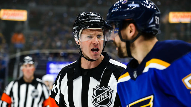 ST. LOUIS, MO - APRIL 14: Referee Gord Dwyer, left, has a conversation with St. Louis Blues' David Perron, right, after the play had ended during the second period of Game 3 of an NHL hockey first-round playoff series between the St. Louis Blues and the Winnipeg Jets on April 14, 2019, at the Enterprise Center in St. Louis, MO.