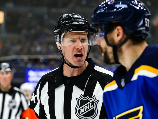 ST. LOUIS, MO - APRIL 14: Referee Gord Dwyer, left, has a conversation with St. Louis Blues' David Perron, right, after the play had ended during the second period of Game 3 of an NHL hockey first-round playoff series between the St. Louis Blues and the Winnipeg Jets on April 14, 2019, at the Enterprise Center in St. Louis, MO.