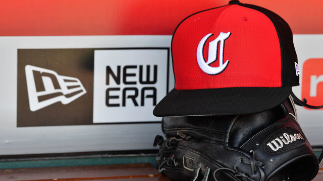 CINCINNATI, OH - MAY 14: A close up view of a hat and baseball glove in the dugout with the New Era logo before a game between the Cincinnati Reds and the Chicago Cubs at Great American Ball Park on May 14, 2019 in Cincinnati, Ohio. Chicago defeated Cincinnati 3-1. *** Local Caption ***