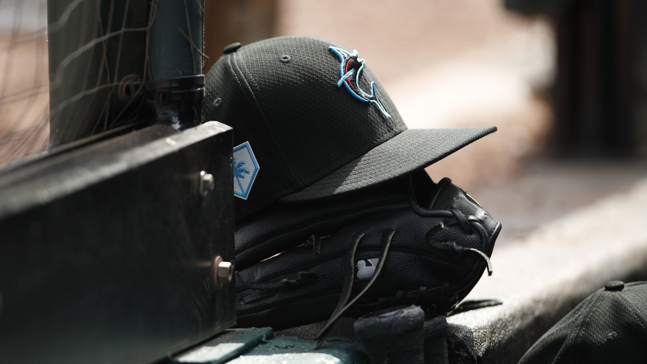 BRADENTON, FL - FEBRUARY 24: A Miami Marlins hat and glove on the step of the dugout during the Spring Training game against the Pittsburgh Pirates at LECOM Park on February 24, 2019 in Bradenton, Florida.