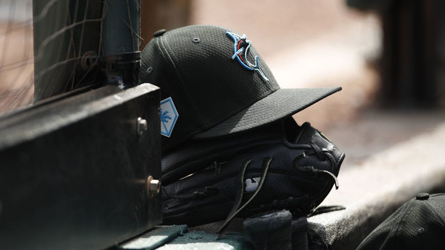 BRADENTON, FL - FEBRUARY 24: A Miami Marlins hat and glove on the step of the dugout during the Spring Training game against the Pittsburgh Pirates at LECOM Park on February 24, 2019 in Bradenton, Florida.