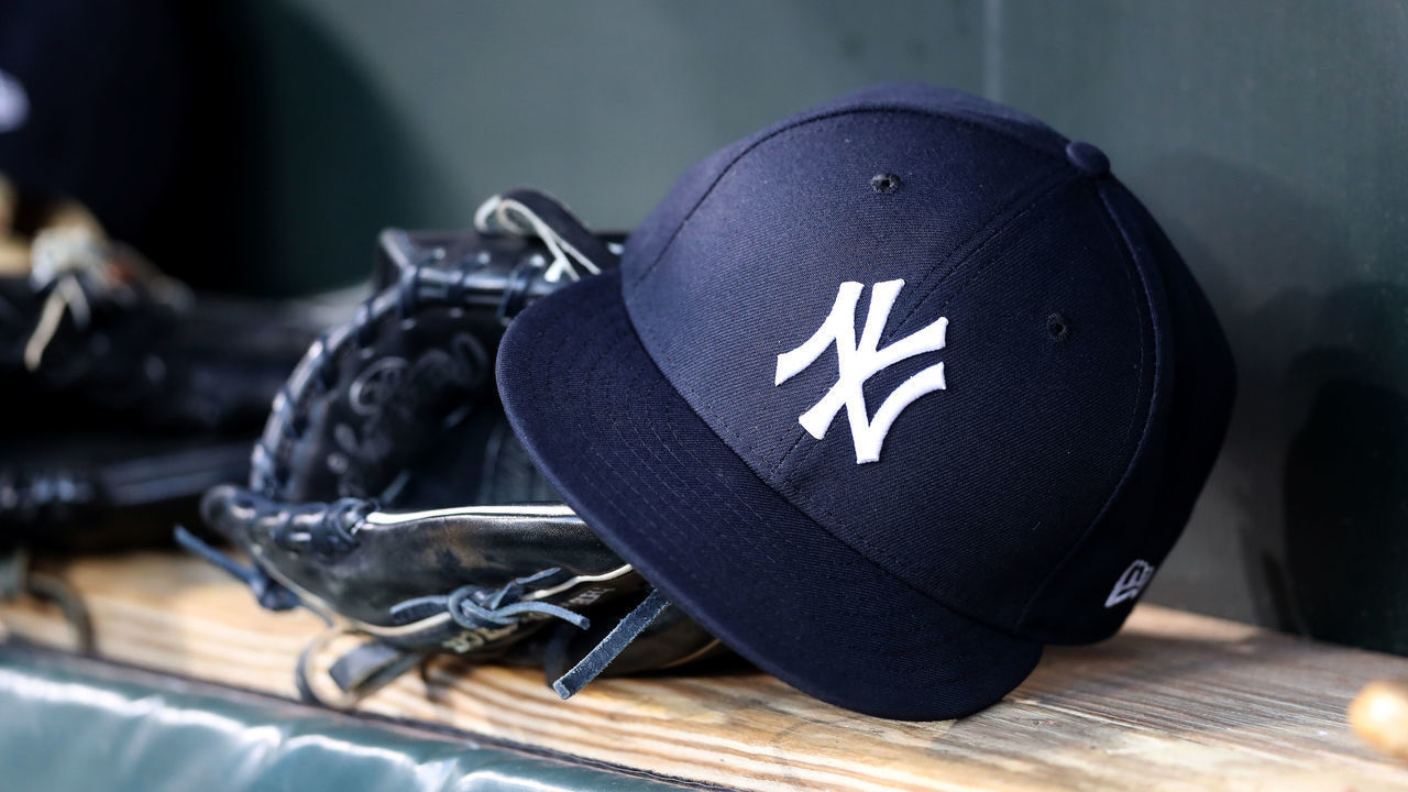 BALTIMORE, MARYLAND - APRIL 06: A New York Yankees hat and glove sit in the dugout before the start of the Yankees and Baltimore Orioles game at Oriole Park at Camden Yards on April 06, 2019 in Baltimore, Maryland.