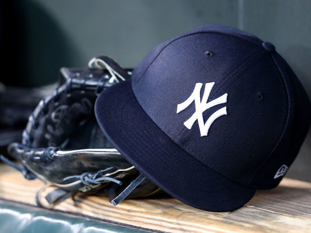 BALTIMORE, MARYLAND - APRIL 06: A New York Yankees hat and glove sit in the dugout before the start of the Yankees and Baltimore Orioles game at Oriole Park at Camden Yards on April 06, 2019 in Baltimore, Maryland.