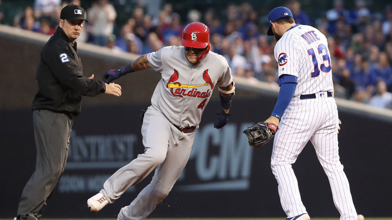 CHICAGO, ILLINOIS - MAY 05: Yadier Molina #4 of the St. Louis Cardinals sprints to third base on a throwing error following his two RBI double during the sixth inning of a game against the Chicago Cubs at Wrigley Field on May 05, 2019 in Chicago, Illinois.