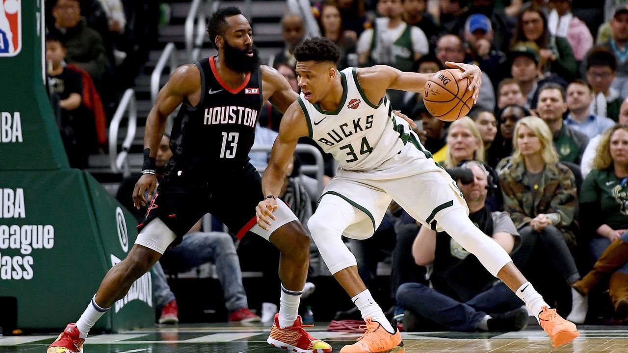 MILWAUKEE, WISCONSIN - MARCH 26: Giannis Antetokounmpo #34 of the Milwaukee Bucks is defended by James Harden #13 of the Houston Rockets during the second half of a game at Fiserv Forum on March 26, 2019 in Milwaukee, Wisconsin.