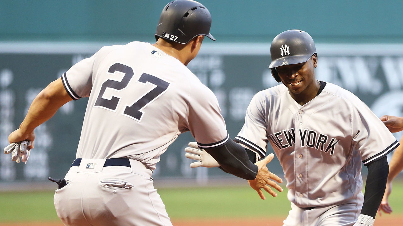BOSTON, MA - AUGUST 2: Didi Gregorius #18 high fives Giancarlo Stanton #27 of the New York Yankees after hitting a three-run home run in the first inning of a game against the Boston Red Sox at Fenway Park on August 2, 2018 in Boston, Massachusetts.