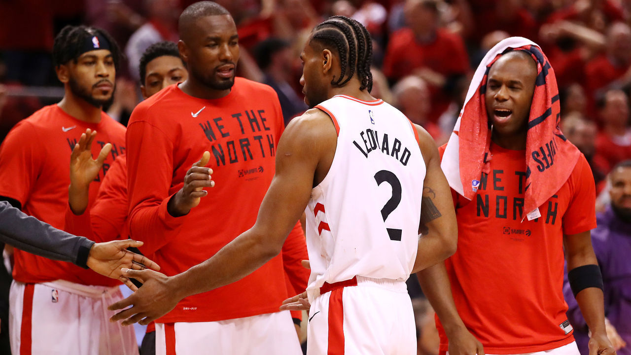 TORONTO, ONTARIO - MAY 19: Kawhi Leonard #2 of the Toronto Raptors celebrates with teammates on the bench during overtime against the Milwaukee Bucks in game three of the NBA Eastern Conference Finals at Scotiabank Arena on May 19, 2019 in Toronto, Canada.