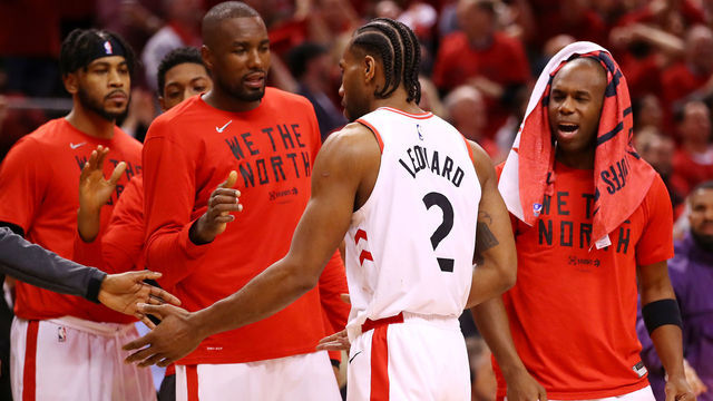 TORONTO, ONTARIO - MAY 19: Kawhi Leonard #2 of the Toronto Raptors celebrates with teammates on the bench during overtime against the Milwaukee Bucks in game three of the NBA Eastern Conference Finals at Scotiabank Arena on May 19, 2019 in Toronto, Canada.