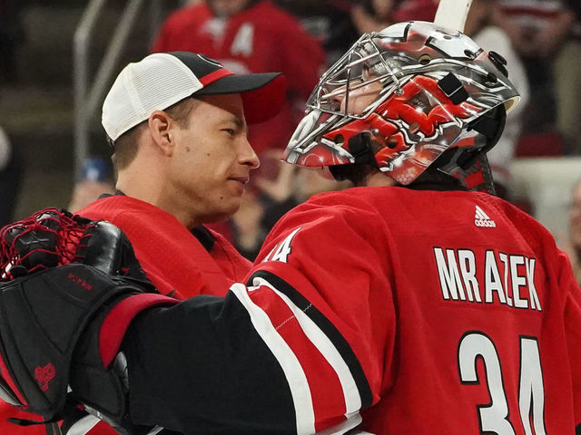 RALEIGH, NC - APRIL 04: Carolina Hurricanes Goalie Curtis McElhinney (35) and Carolina Hurricanes Goalie Petr Mrazek (34) celebrate after the Carolina Hurricanes clinch their first playoff birth since 2009 during a game between the New Jersey Devils and the Carolina Hurricanes at the PNC Arena in Raleigh, NC on April 4, 2019.