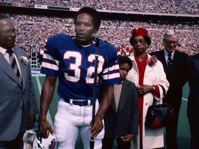 ORCHARD PARK, NY - SEPTEMBER 14: O.J. Simpson, professional football player with the Buffalo Bills, is inducted into the Wall of Fame in Rich Stadium on September 14, 1980. Simpson is accompanied by his parents, his son, Jason, and Ralph Wilson, owner of the Buffalo Bills.