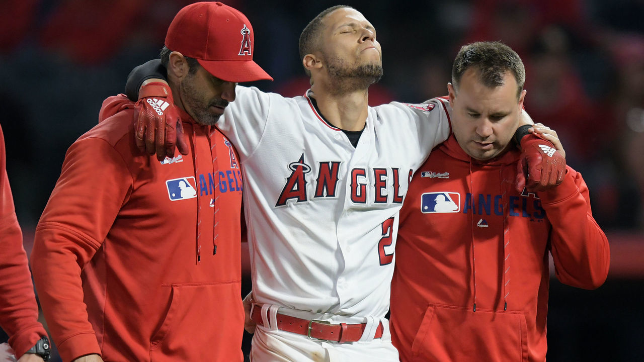 ANAHEIM, CA - MAY 20: Los Angeles Angels shortstop Andrelton Simmons (2) is carried off the field by Manager Brad Ausmus (12) and Athletic Trainer Eric Munson after Simmons fell trying to reach first base safely in the eighth inning of a game against the Minnesota Twins played on May 20, 2019 at Angel Stadium of Anaheim in Anaheim, CA.