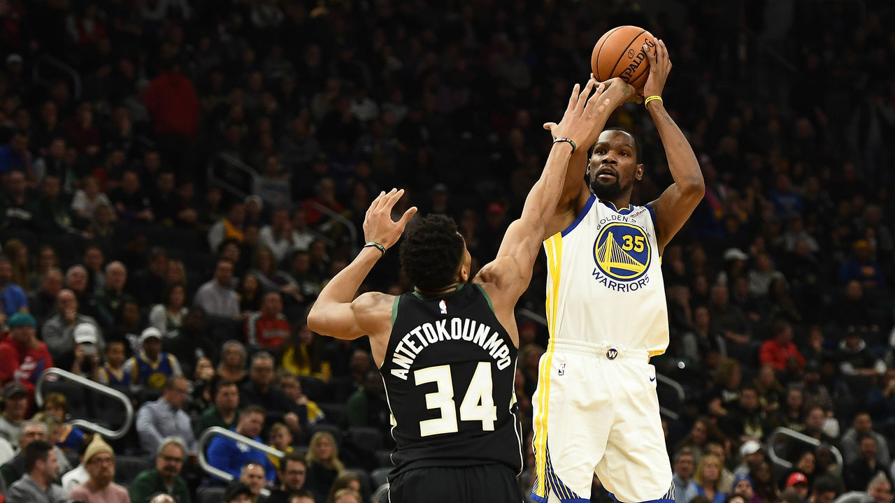 MILWAUKEE, WISCONSIN - DECEMBER 07: Kevin Durant #35 of the Golden State Warriors shoots over Giannis Antetokounmpo #34 of the Milwaukee Bucks during a game at Fiserv Forum on December 07, 2018 in Milwaukee, Wisconsin. The Warriors defeated the Bucks 105-95.