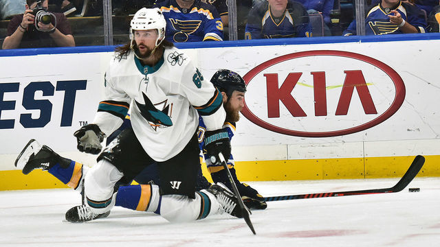 ST. LOUIS, MO - MAY 15: San Jose Sharks defenseman Erik Karlsson (65) and St. Louis Blues center Ryan O'Reilly (90) collide while playing the puck during a NHL Stanley Cup Playoffs Western Conference Final game three between the San Jose Sharks and the St. Louis Blues, on May 15, 2019, at Enterprise Center, St. Louis, Mo.
