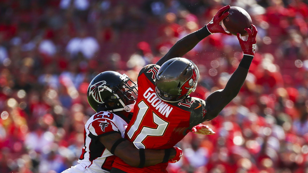 TAMPA, FL - DECEMBER 30: Wide receiver Chris Godwin #12 of the Tampa Bay Buccaneers is wrapped up by cornerback Robert Alford #23 of the Atlanta Falcons as he stretches for a pass from quarterback Jameis Winston #3 of the game at Raymond James Stadium on December 30, 2018 in Tampa, Florida.