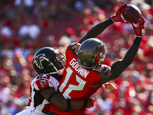 TAMPA, FL - DECEMBER 30: Wide receiver Chris Godwin #12 of the Tampa Bay Buccaneers is wrapped up by cornerback Robert Alford #23 of the Atlanta Falcons as he stretches for a pass from quarterback Jameis Winston #3 of the game at Raymond James Stadium on December 30, 2018 in Tampa, Florida.