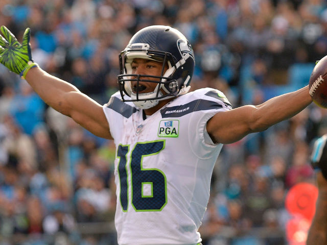 CHARLOTTE, NC - NOVEMBER 25: Tyler Lockett #16 of the Seattle Seahawks celebrates a touchdown against the Carolina Panthers in the third quarter during their game at Bank of America Stadium on November 25, 2018 in Charlotte, North Carolina.