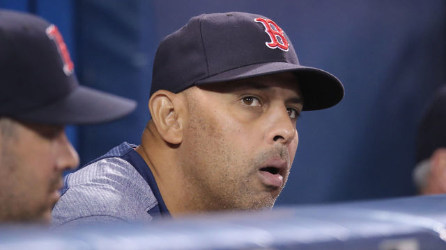 TORONTO, ON - MAY 20: Manager Alex Cora #20 of the Boston Red Sox looks on from the top step of the dugout during MLB game action against the Toronto Blue Jays at Rogers Centre on May 20, 2019 in Toronto, Canada.