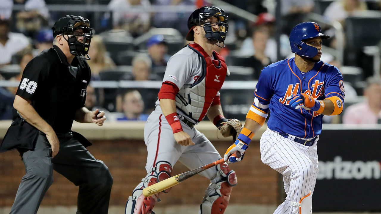 NEW YORK, NEW YORK - MAY 20: Robinson Cano #24 of the New York Mets hits a double in the sixth inning as Yan Gomes #10 of the Washington Nationals defends at Citi Field on May 20, 2019 in the Flushing neighborhood of the Queens borough of New York City.