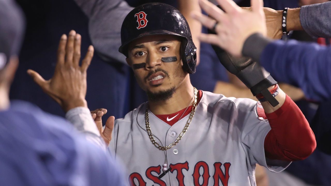 TORONTO, ON - MAY 20: Mookie Betts #50 of the Boston Red Sox is congratulated by teammates in the dugout after scoring a run in the third inning during MLB game action against the Toronto Blue Jays at Rogers Centre on May 20, 2019 in Toronto, Canada.