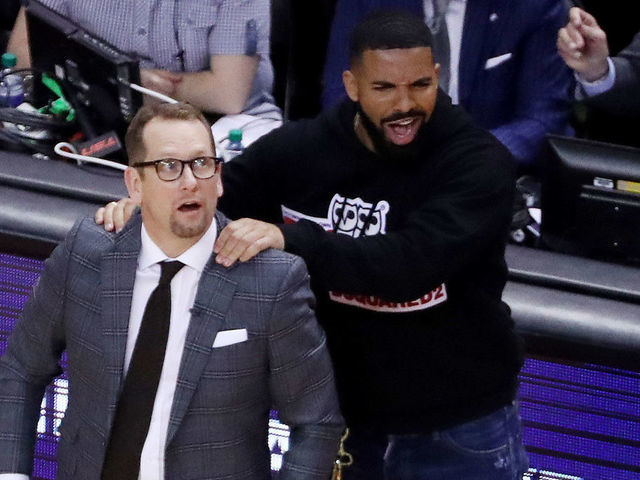 TORONTO, ON- MAY 21 - Drake massages Toronto Raptors head coach Nick Nurse's shoulder as the Toronto Raptors beat the Milwaukee Bucks in game four 120-102 to even up the Eastern Conference NBA Final at two games each at Scotiabank Arena in Toronto. May 21, 2019. (Steve Russell/Toronto Star via Getty Images)
