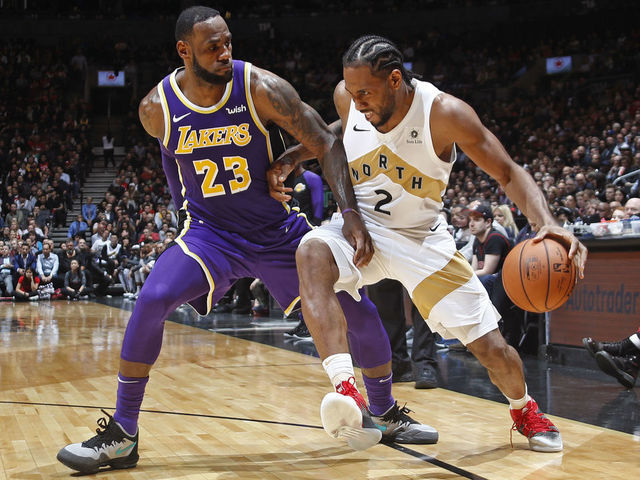 TORONTO, CANADA - MARCH 14: Kawhi Leonard #2 of the Toronto Raptors handles the ball against LeBron James #23 of the Los Angeles Lakers on March 14, 2019 at the Scotiabank Arena in Toronto, Ontario, Canada. Mandatory Copyright Notice: Copyright 2019 NBAE