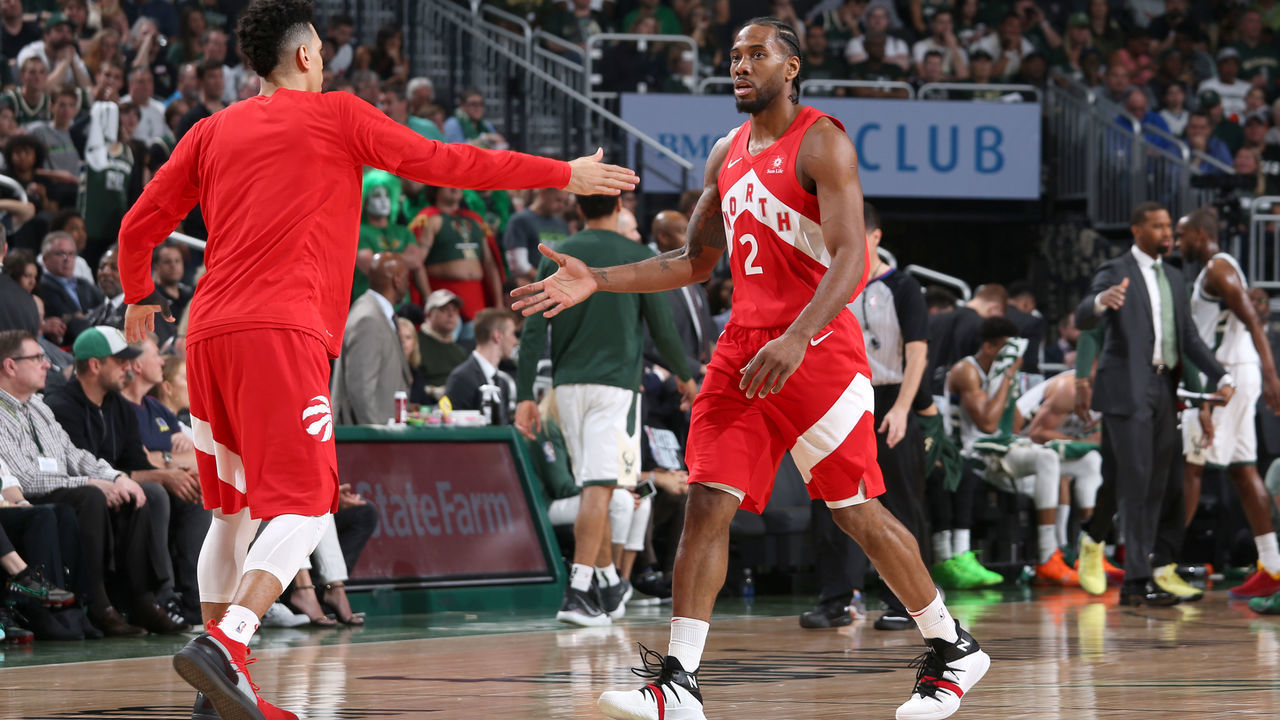 MILWAUKEE, WI - MAY 23: Danny Green #14 and Kawhi Leonard #2 of the Toronto Raptors high five during Game Five of the Eastern Conference Finals against the Milwaukee Bucks on May 23, 2019 at the Fiserv Forum in Milwaukee, Wisconsin. NOTE TO USER: User expressly acknowledges and agrees that, by downloading and/or using this photograph, user is consenting to the terms and conditions of the Getty Images License Agreement. Mandatory Copyright Notice: Copyright 2019 NBAE
