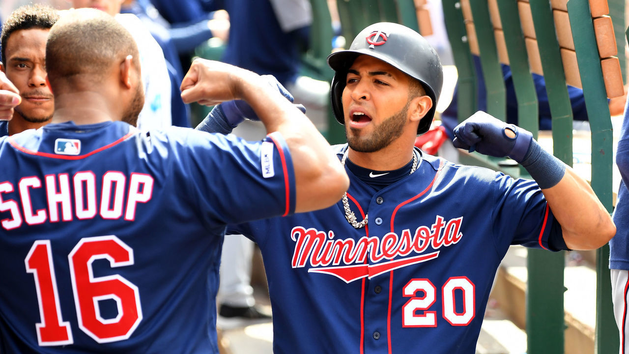 ANAHEIM, CA - MAY 23: Eddie Rosario #20 is congratulated in the dugout by Jonathan Schoop #16 of the Minnesota Twins after hitting a solo home run in the seventh inning against the Los Angeles Angels of Anaheim at Angel Stadium of Anaheim on May 23, 2019 in Anaheim, California.