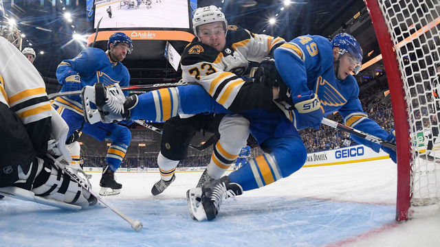 ST. LOUIS, MO - FEBRUARY 23: Charlie McAvoy #73 of the Boston Bruins checks Ivan Barbashev #49 of the St. Louis Blues at Enterprise Center on February 23, 2019 in St. Louis, Missouri.
