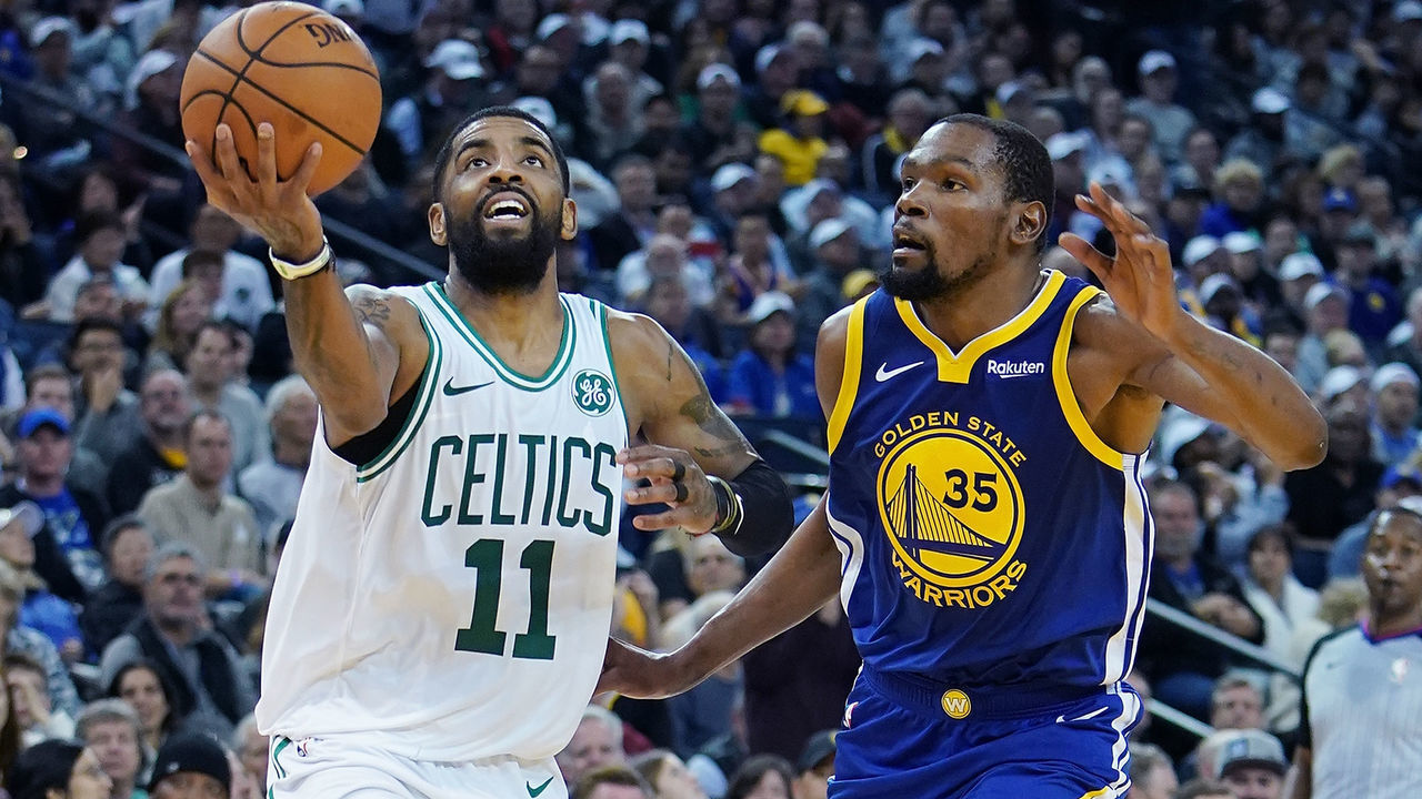 OAKLAND, CA - MARCH 05: Kyrie Irving #11 of the Boston Celtics drives to the basket on Kevin Durant #35 of the Golden State Warriors during an NBA basketball game at ORACLE Arena on March 5, 2019 in Oakland, California.