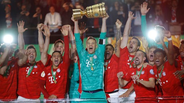 Bayern Munich players celebrate with the trophy after the German Cup (DFB Pokal) Final football match RB Leipzig v FC Bayern Munich at the Olympic Stadium in Berlin on May 25, 2019.