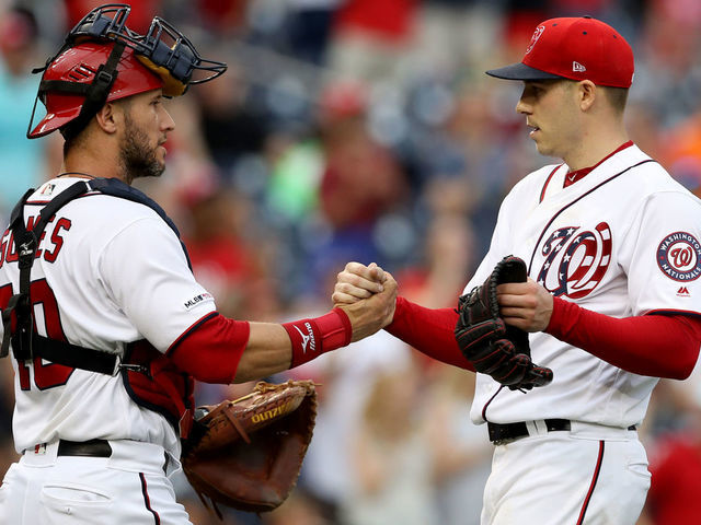 WASHINGTON, DC - MAY 25: Starting pitcher Patrick Corbin #46 of the Washington Nationals celebrates with catcher Yan Gomes #10 after throwing a complete game shutout against the Miami Marlins in the first inning at Nationals Park on May 25, 2019 in Washington, DC.