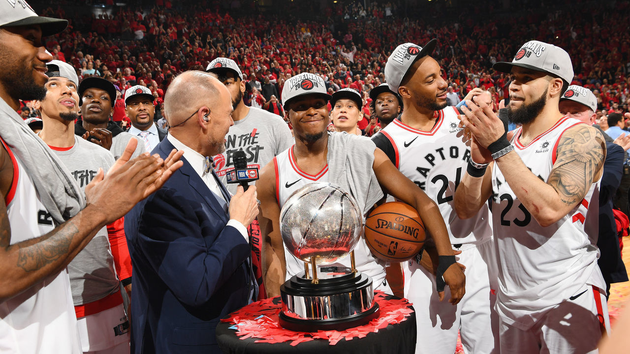 TORONTO, CANADA - MAY 25: Ernie Johnson Jr. presents the Eastern Conference Finals Trophy to Kyle Lowry #7 of the Toronto Raptors during Game Six of the Eastern Conference Finals on May 25, 2019 at Scotiabank Arena in Toronto, Ontario, Canada. NOTE TO USER: User expressly acknowledges and agrees that, by downloading and/or using this photograph, user is consenting to the terms and conditions of the Getty Images License Agreement. Mandatory Copyright Notice: Copyright 2019 NBAE