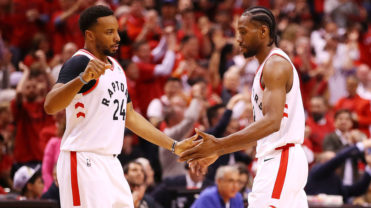 TORONTO, ONTARIO - MAY 21: Norman Powell #24 of the Toronto Raptors high fives Kawhi Leonard #2 during the second half against the Milwaukee Bucks in game four of the NBA Eastern Conference Finals at Scotiabank Arena on May 21, 2019 in Toronto, Canada.