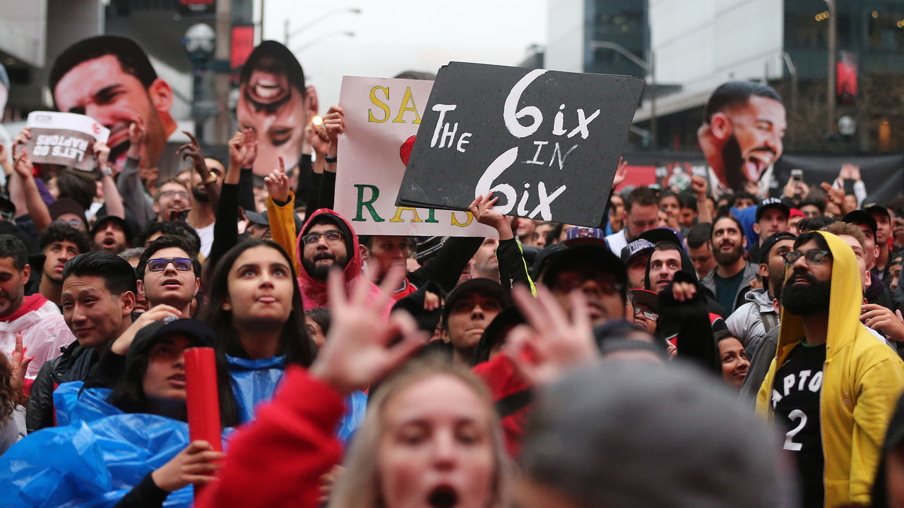 TORONTO, ON- MAY 25 - Toronto fans, some with signs and Drake cutouts, cheer in Jurassic Park as the Toronto Raptors play the Milwaukee Bucks in game six of the NBA Eastern Conference Final in Toronto. May 25, 2019. (Steve Russell/Toronto Star via Getty Images)