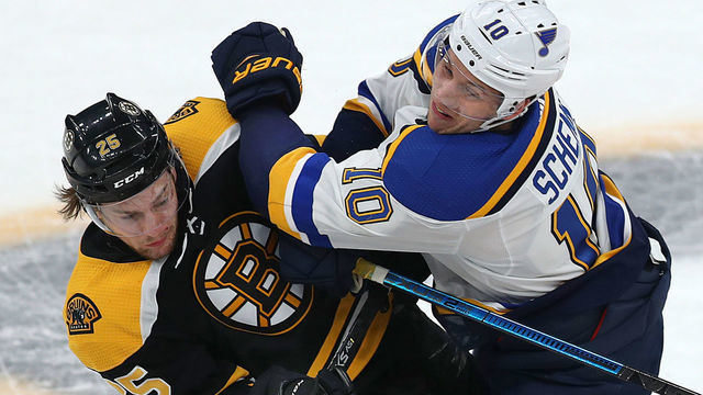 BOSTON - JANUARY 17: Boston Bruins' Brandon Carlo collides with the Blues' Brayden Schenn in the first period. The Boston Bruins host the St. Louis Blues in a regular season NHL hockey game at TD Garden in Boston on Jan. 17, 2019.
