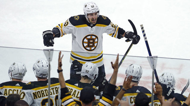 RALEIGH - MAY 16: After he scored the final goal in the Bruins 4-0 victory, Brad Marchand celebrated with teammates as well as Boton fans behind the bench. The Boston Bruins visited the Carolina Hurricanes for Game Four of the Stanley Cup Eastern Conference Finals NHL playoff series at PNC Arena in Raleigh, North Carolina.