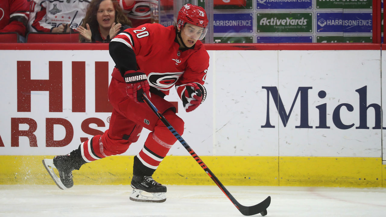 RALEIGH, NC - MARCH 28: Sebastian Aho #20 of the Carolina Hurricanes skates with the puck along the boards during an NHL game against the Washington Capitals on March 28, 2019 at PNC Arena in Raleigh, North Carolina.