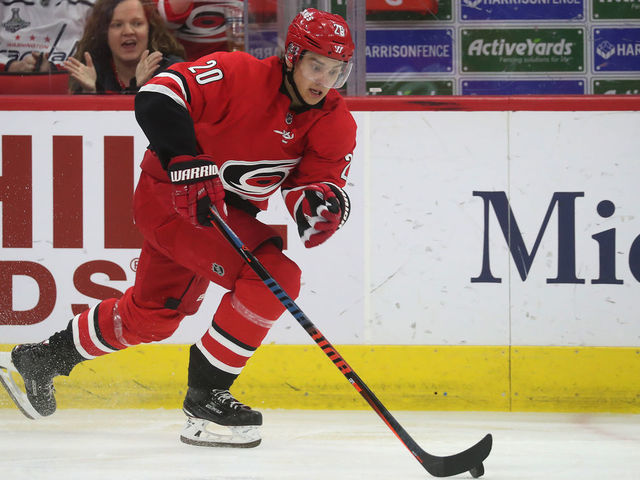 RALEIGH, NC - MARCH 28: Sebastian Aho #20 of the Carolina Hurricanes skates with the puck along the boards during an NHL game against the Washington Capitals on March 28, 2019 at PNC Arena in Raleigh, North Carolina.