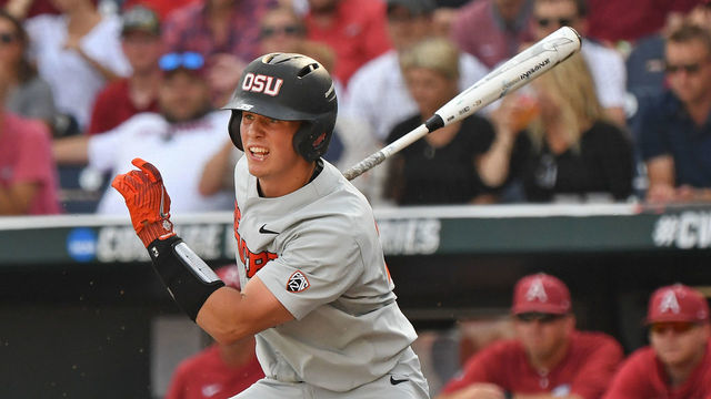 Omaha, NE - JUNE 28: Catcher Adley Rutschman #35 of the Oregon State Beavers singes in a run in the first inning against the Arkansas Razorbacks during game three of the College World Series Championship Series on June 28, 2018 at TD Ameritrade Park in Omaha, Nebraska.