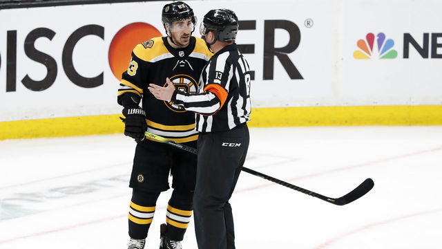 BOSTON, MA - APRIL 19: Boston Bruins left wing Brad Marchand (63) speaks with referee Dan O'Halloran (13) during Game 5 of the First Round Stanley Cup Playoffs between the Boston Bruins and the Toronto Maple Leafs on April 19, 2019, at TD garden in Boston, Massachusetts.